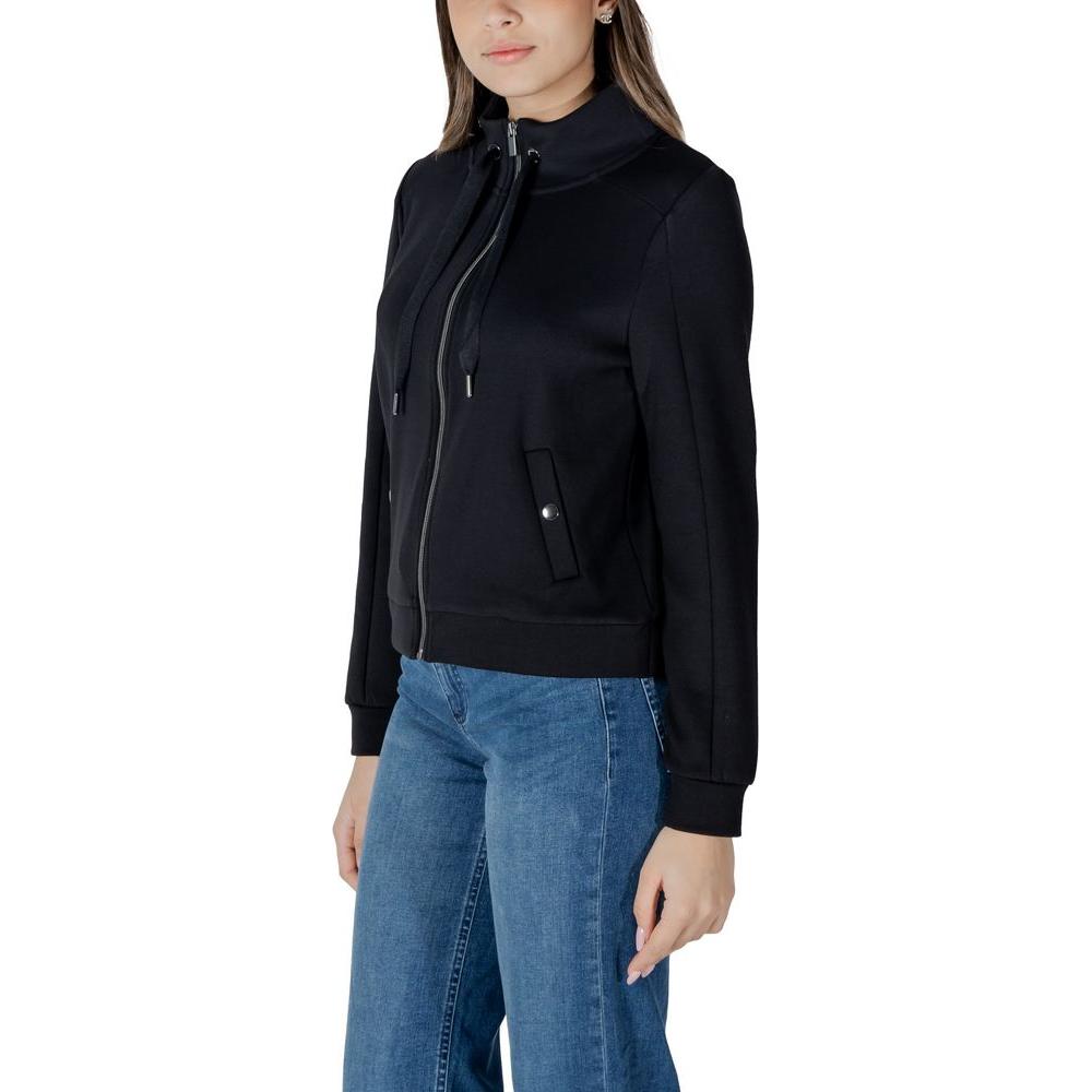 Woman wearing Street One black cotton sweater with zip closure, paired with blue jeans, showcasing women's casual fashion.