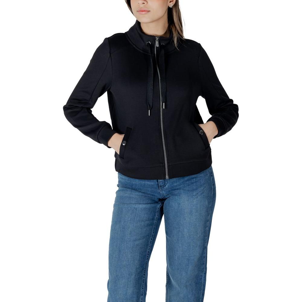 Woman wearing Street One Black Cotton Sweater with zip, hands in pockets; casual women's fashion, cotton-polyester-lycra blend.
