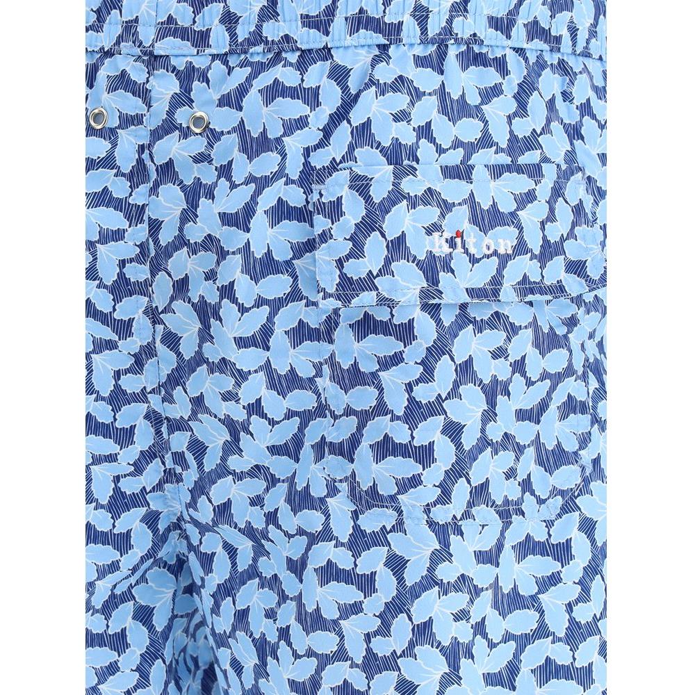 Stylish Kiton logoed swimshorts with blue leaf pattern, featuring adjustable waistband, drawstring, and embroidered monogram on back pocket.