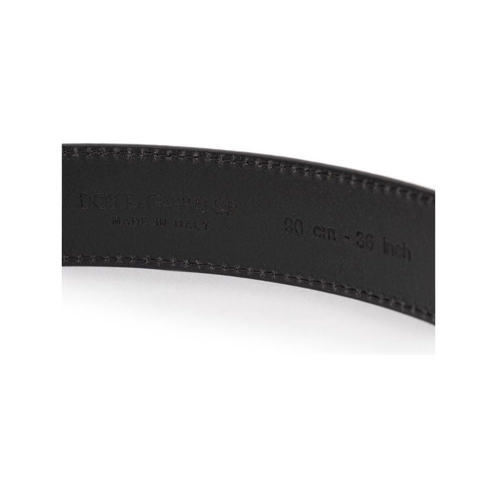 Close-up of Dolce & Gabbana black leather belt with grained calfskin texture, showing inside engraving 'Made in Italy' and size 90 cm.