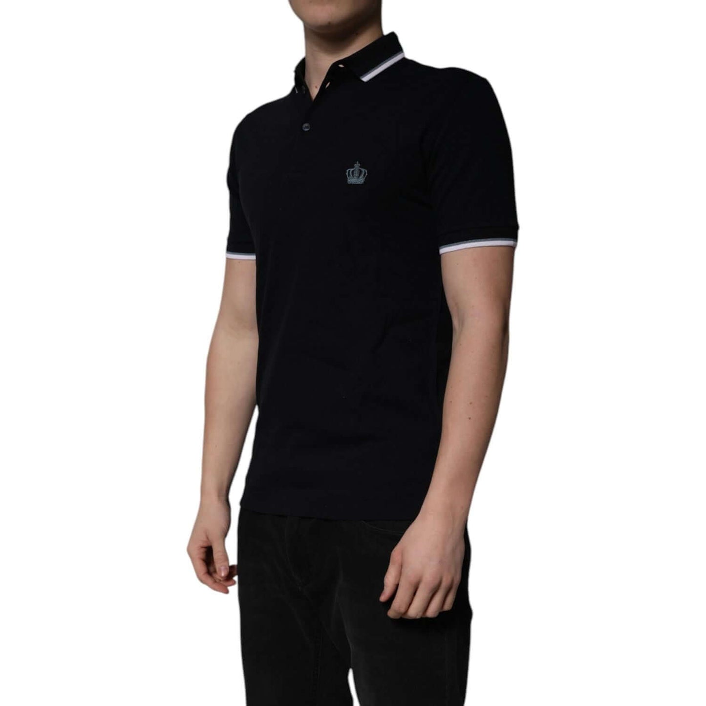 Dolce & Gabbana black cotton polo t-shirt with crown embroidery, short sleeves, regular fit, button closure, worn by a model.