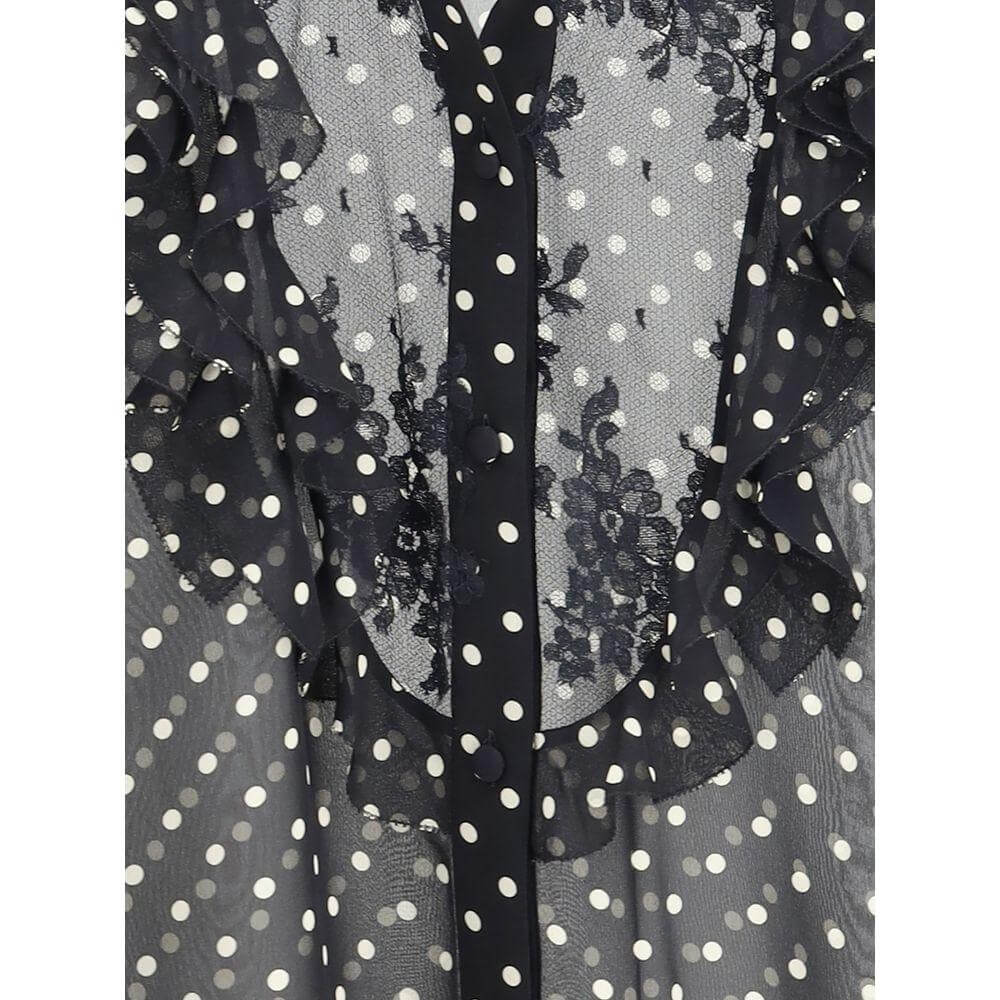 Close-up of Valentino silk shirt with polka dot pattern, mandarin collar, lace details, and ruffled embellishments.