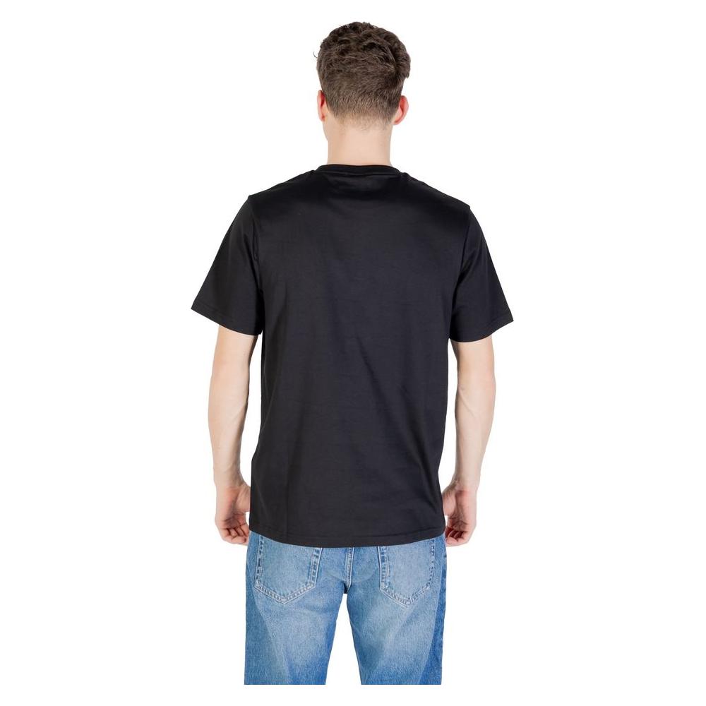Back view of a man wearing a Lyle & Scott black cotton T-shirt paired with blue jeans, showcasing the short-sleeve design.