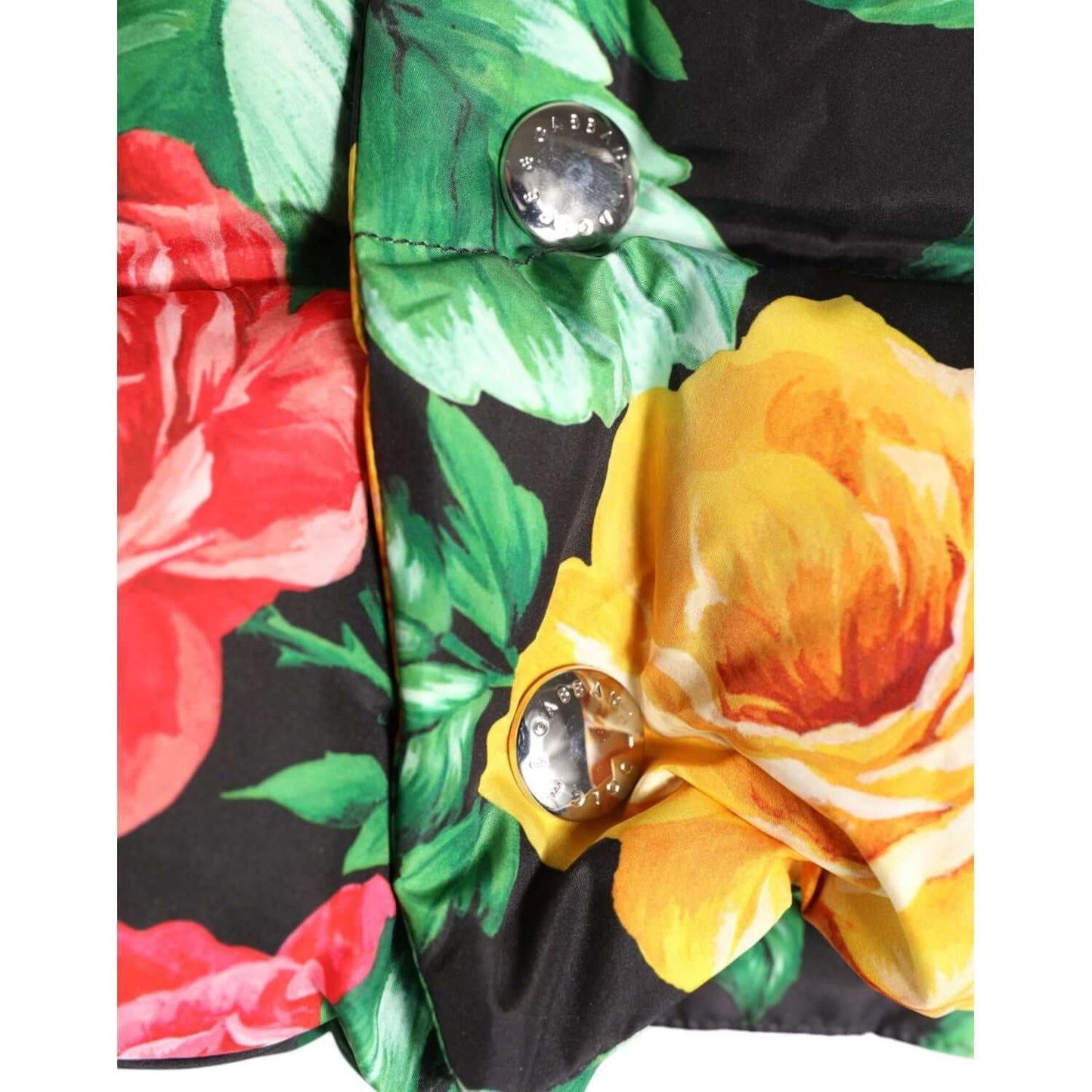 Close-up of Dolce & Gabbana multicolor floral print head wrap hat with logo buttons and vibrant rose pattern.