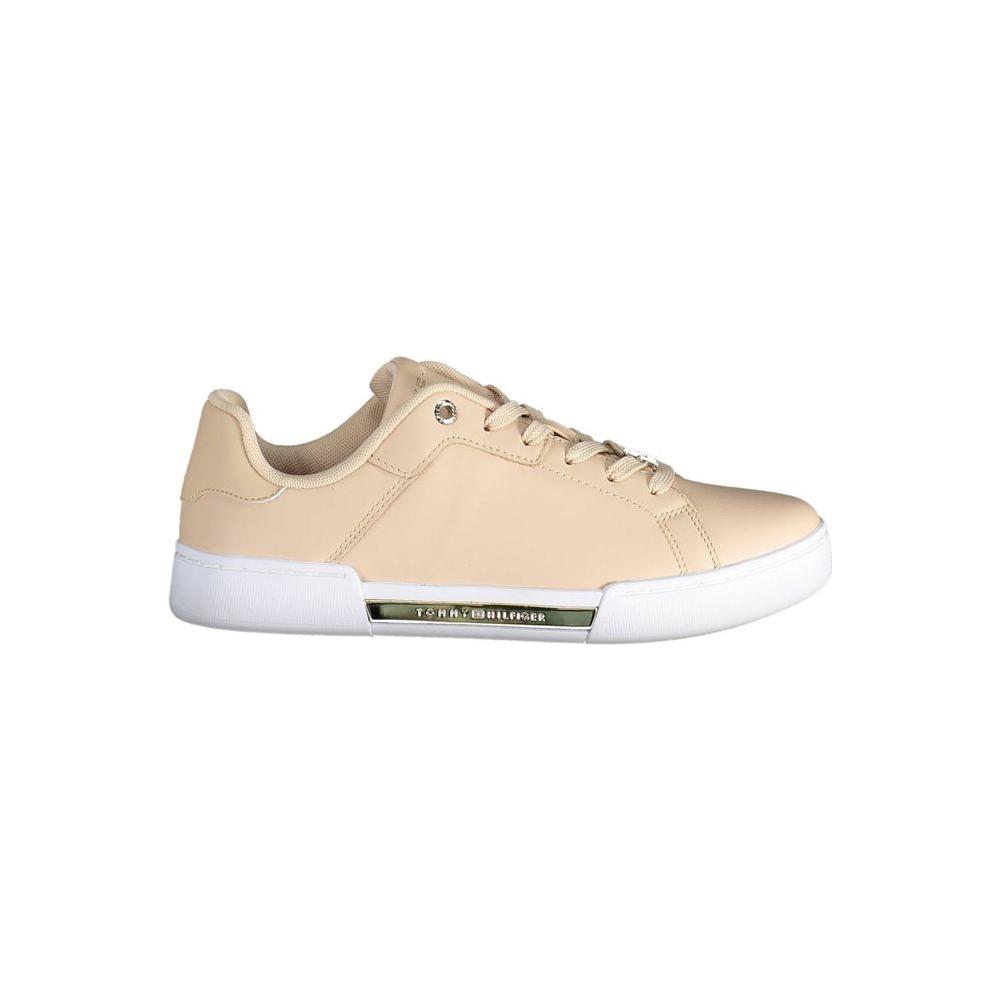 Tommy Hilfiger pink leather women sneaker with white sole, side view showcasing sleek design and brand logo.