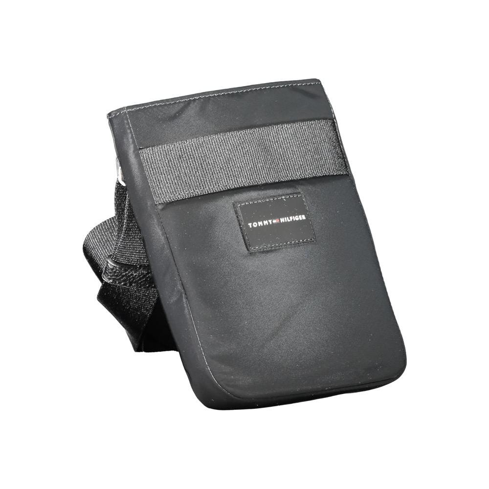 Tommy Hilfiger black polyester shoulder bag with adjustable strap, external and internal pockets, zip closure, and logo