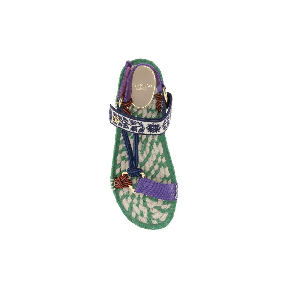 Top view of Valentino Garavani Lake Powell sandal with green sole and adjustable Velcro straps featuring metallic VLogo.