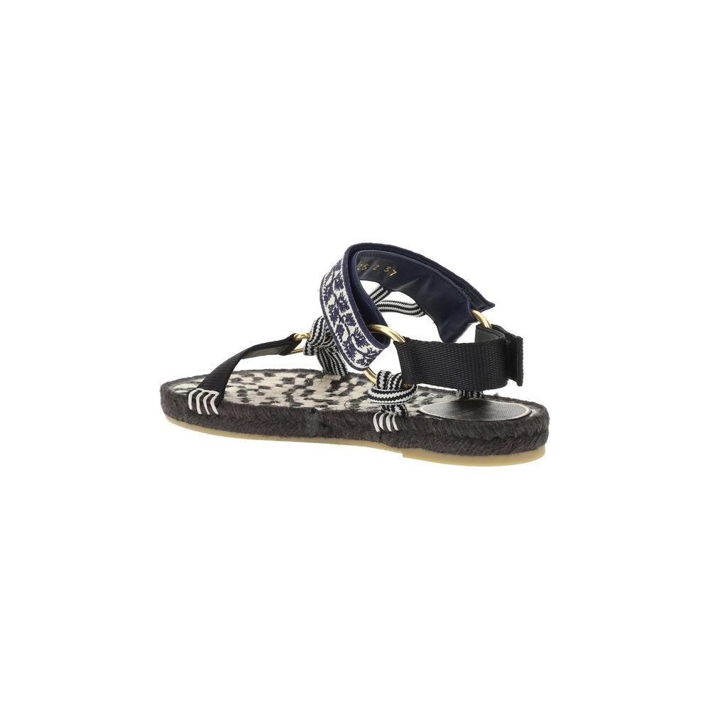 Valentino Garavani Lake Powell Sandals with flat rope sole, round toe, double Velcro strap, and metallic VLogo on front strap.