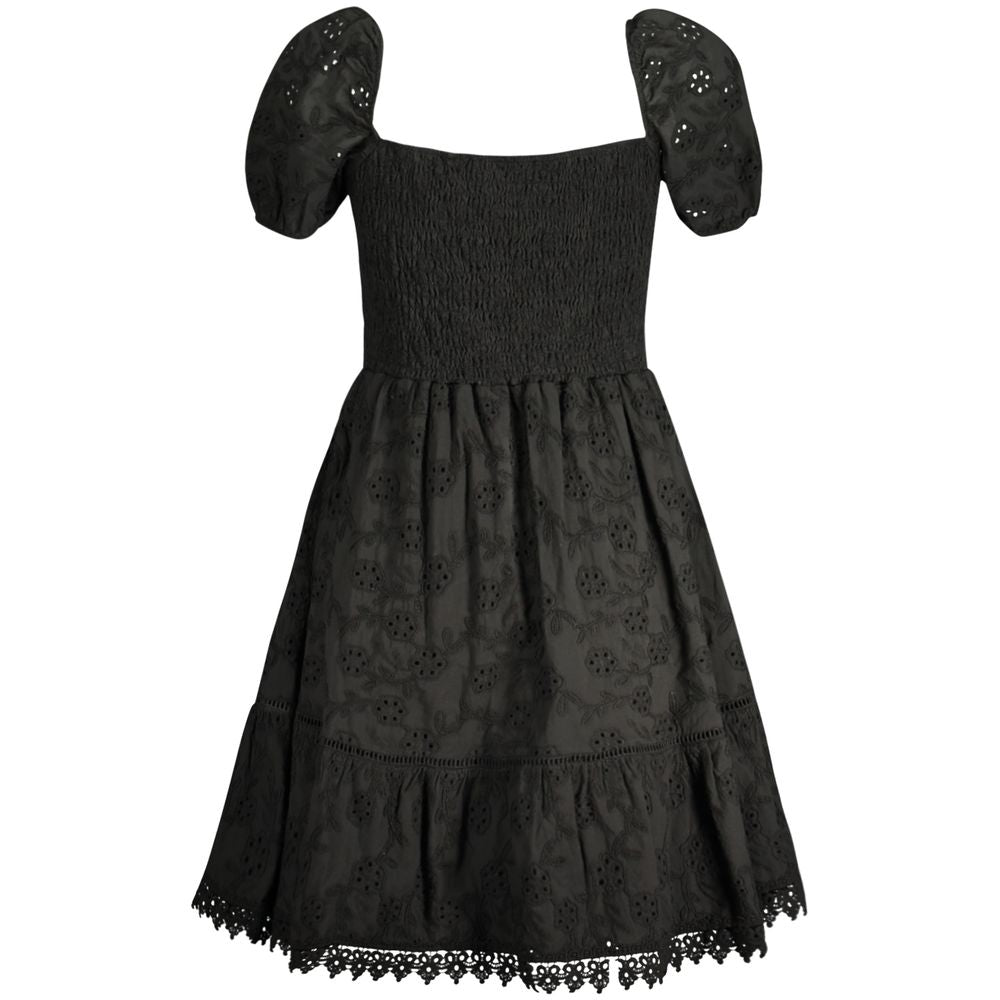 Elegant black cotton Guess jeans dress with short sleeves and embroidery, featuring a boat neck and Guess logo.