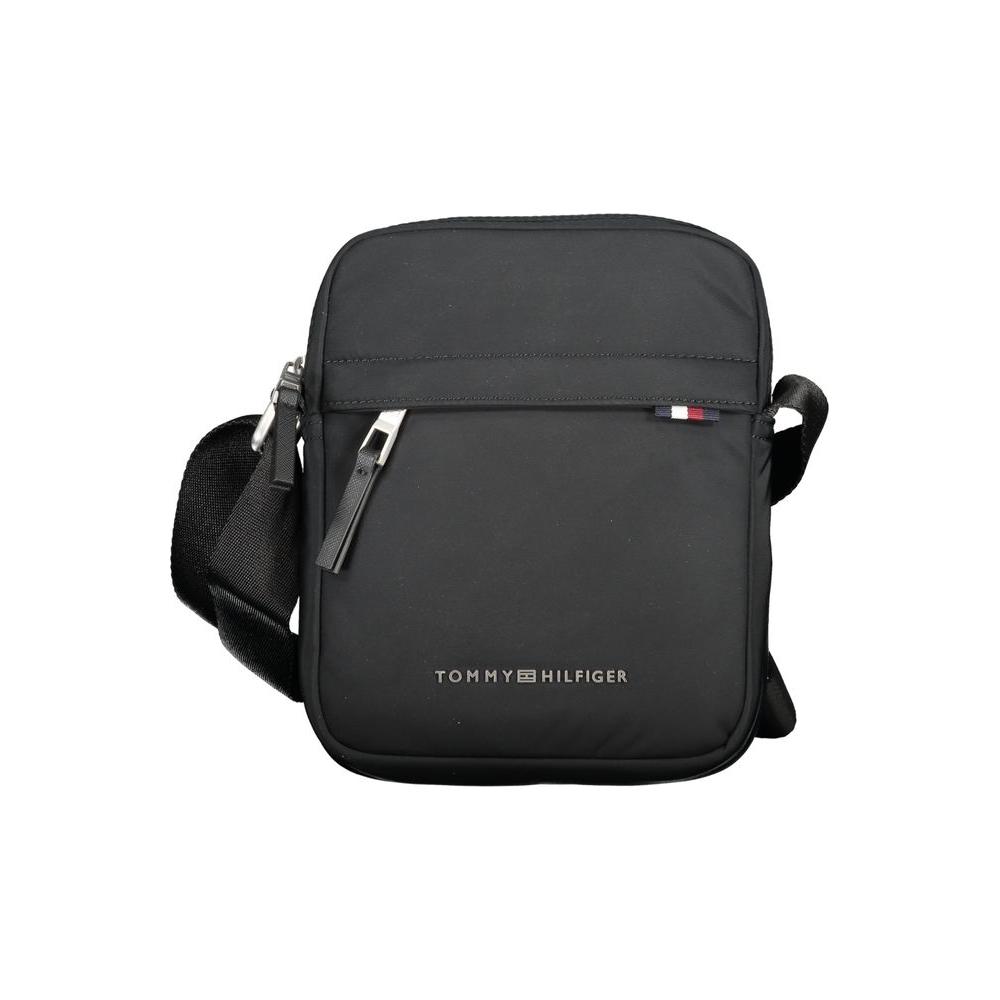 Tommy Hilfiger black polyester shoulder bag with adjustable strap, zip closure, and logo branding, made from recycled materials.