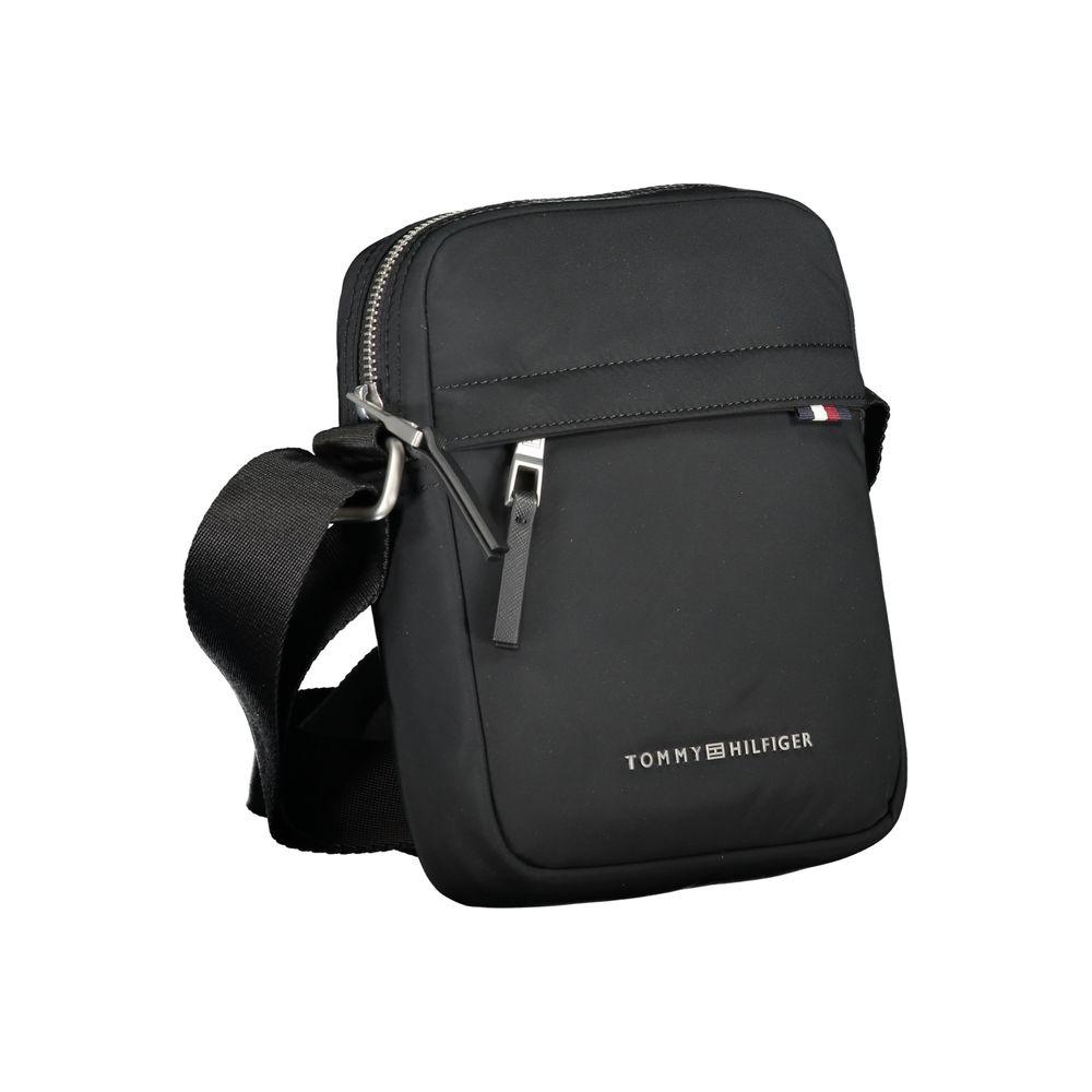 Tommy Hilfiger black shoulder bag with adjustable strap, zip closure, and logo. Made from recycled polyester. Features multiple pockets.