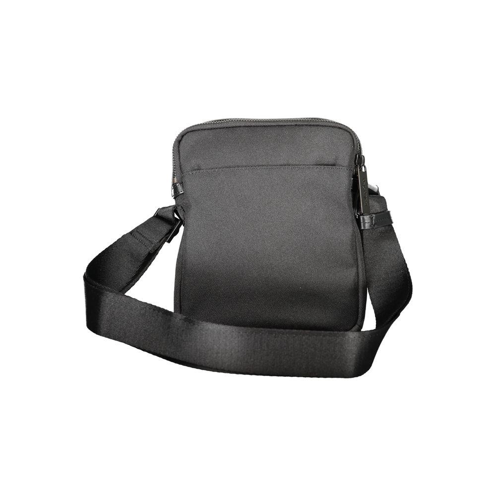Calvin Klein black polyester men's shoulder bag with adjustable strap and zip closure, minimalist design for comfort and style.