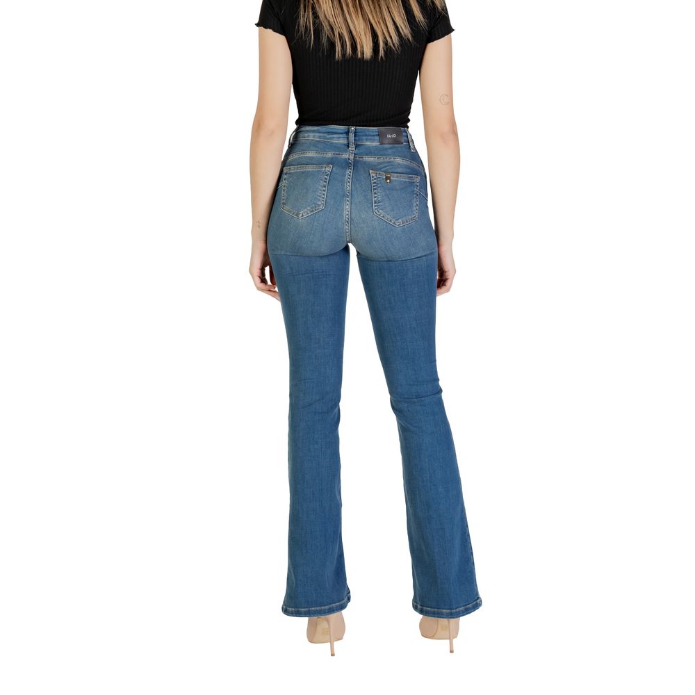 Back view of woman wearing Liu Jo blue flared cotton jeans with high waist, showcasing bootcut silhouette and comfortable fit.