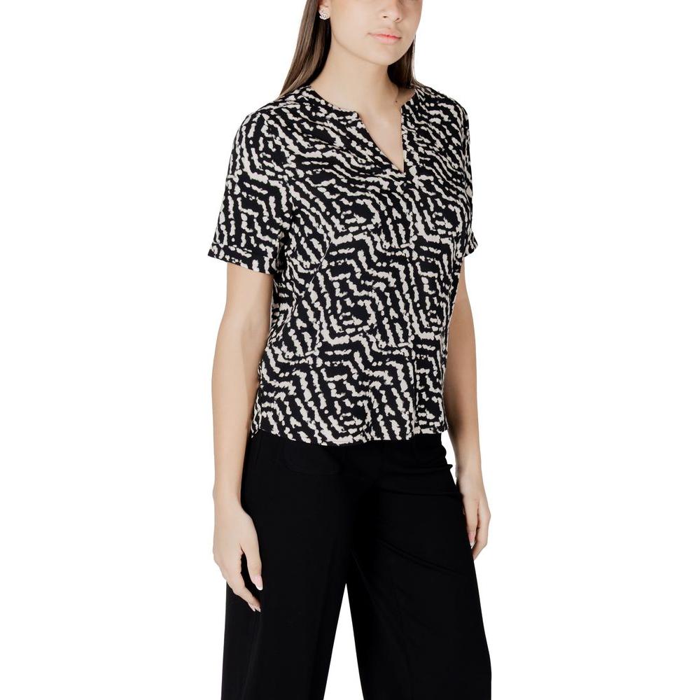 Woman wearing Street One black viscose shirt with short sleeves and V-neck, paired with black pants, showcasing a chic casual look.