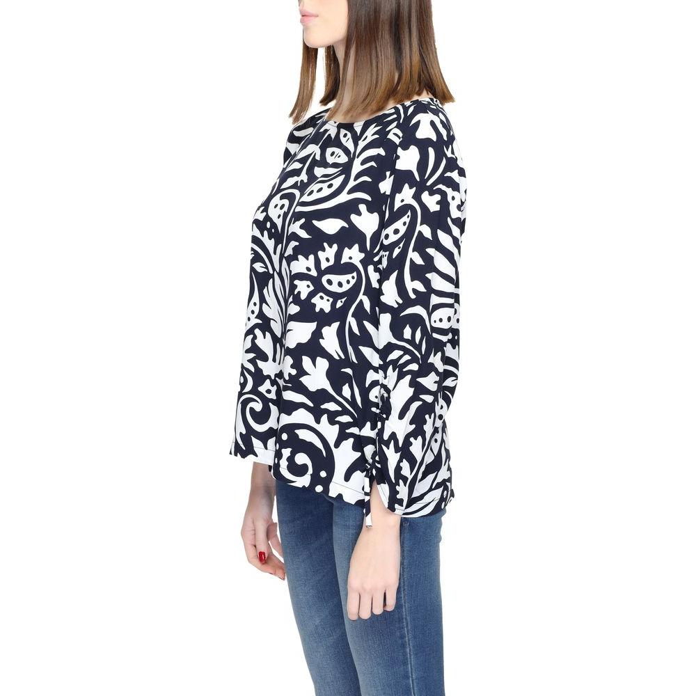 Woman wearing Street One blue viscose long sleeve blouse with abstract pattern, side view.