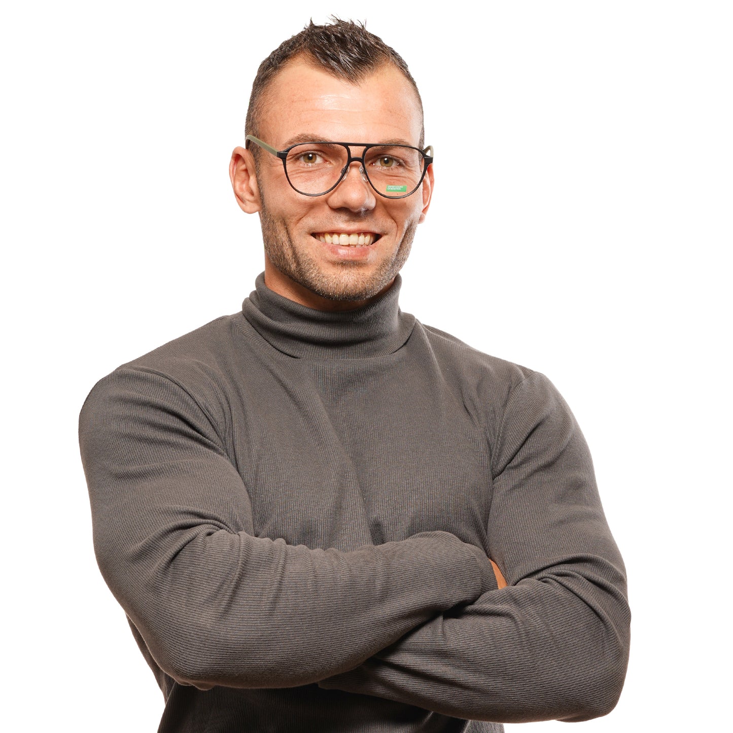 Man wearing BENETTON MOD. BEO1008 56001 glasses with a grey turtleneck, arms crossed, smiling confidently, designed for gent