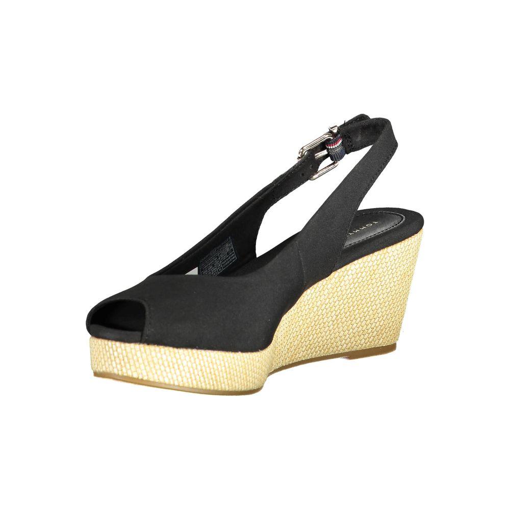 Tommy Hilfiger black leather women's sandal with ankle buckle and 7 cm heel, featuring sleek design and iconic logo for stylish elegance.