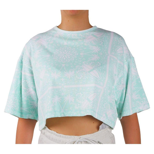 Person wearing a cropped pastel green t-shirt with abstract patterns and short sleeves.