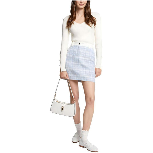 Woman wearing Morgan De Toi blue polyester miniskirt, part of the spring/summer collection, styled with a white top and handbag.