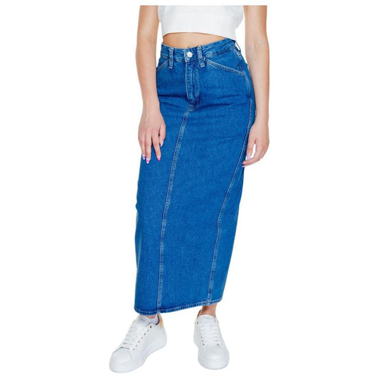Woman wearing a Calvin Klein Jeans blue cotton long skirt from the Fall/Winter collection, made of 80% cotton and 20% recycled cotton.