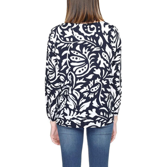 Back view of woman wearing Street One blue viscose shirt with long sleeves and white floral pattern, 100% viscose fabric.